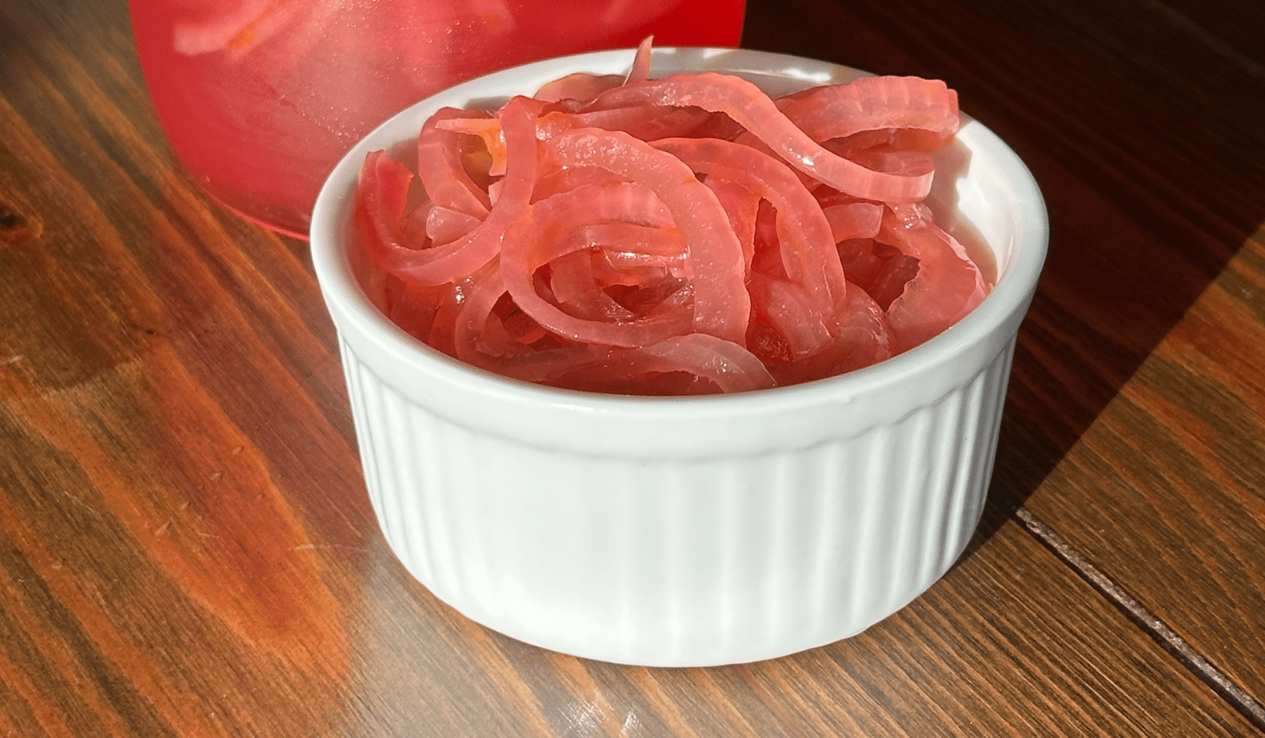 pickled red onions in a white ramekin