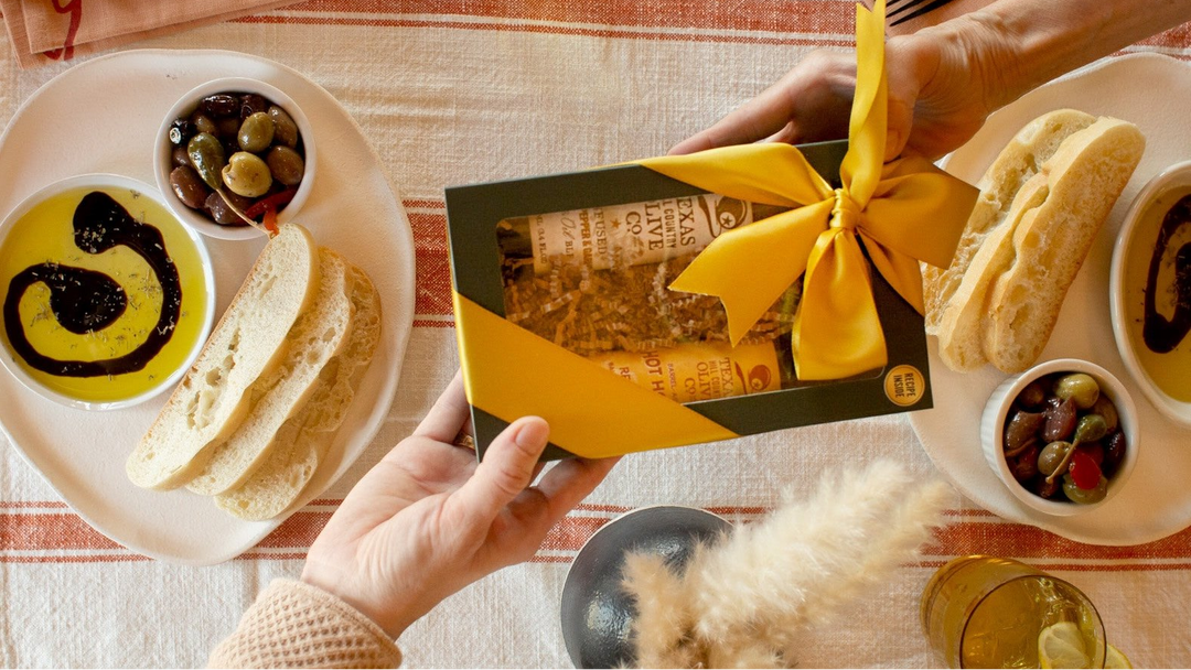 top selling hostess gift offered over a meal of olive oil dip and bread with olives.