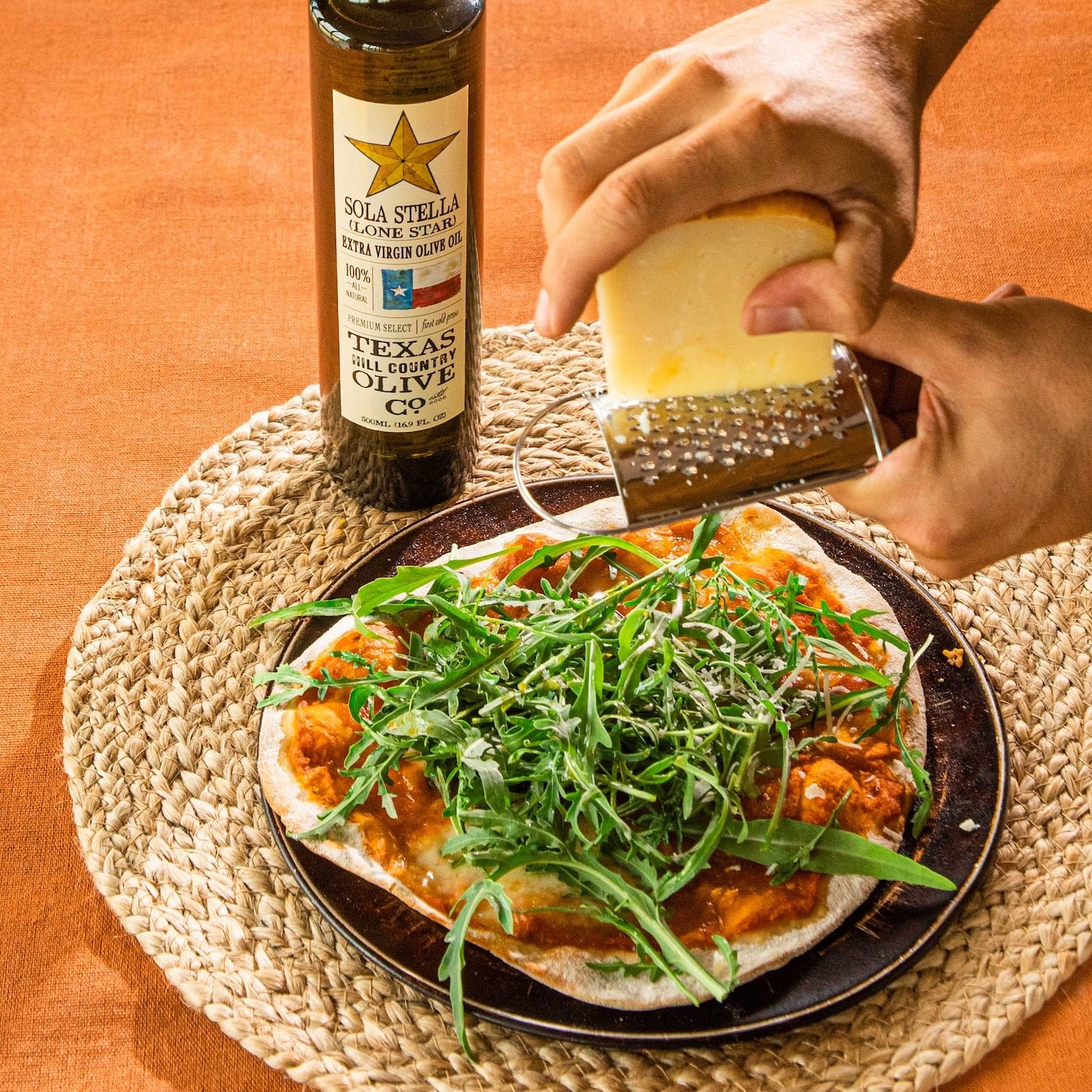500ml Bottle of Sola Stella Lone Star Extra Virgin Olive Oil alongside a pizza