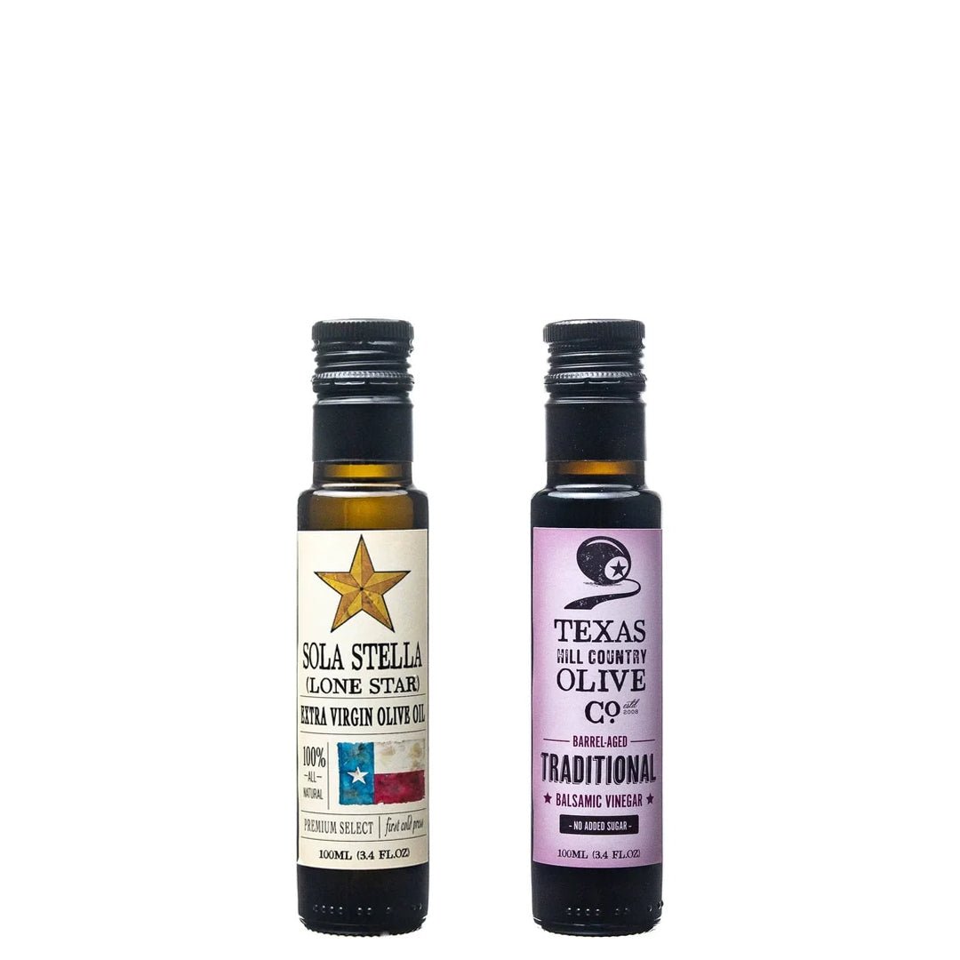 100 ml bottles of Sola Stella Extra Virgin Olive Oil and Traditional Aged Balsamic Vinegar on white.